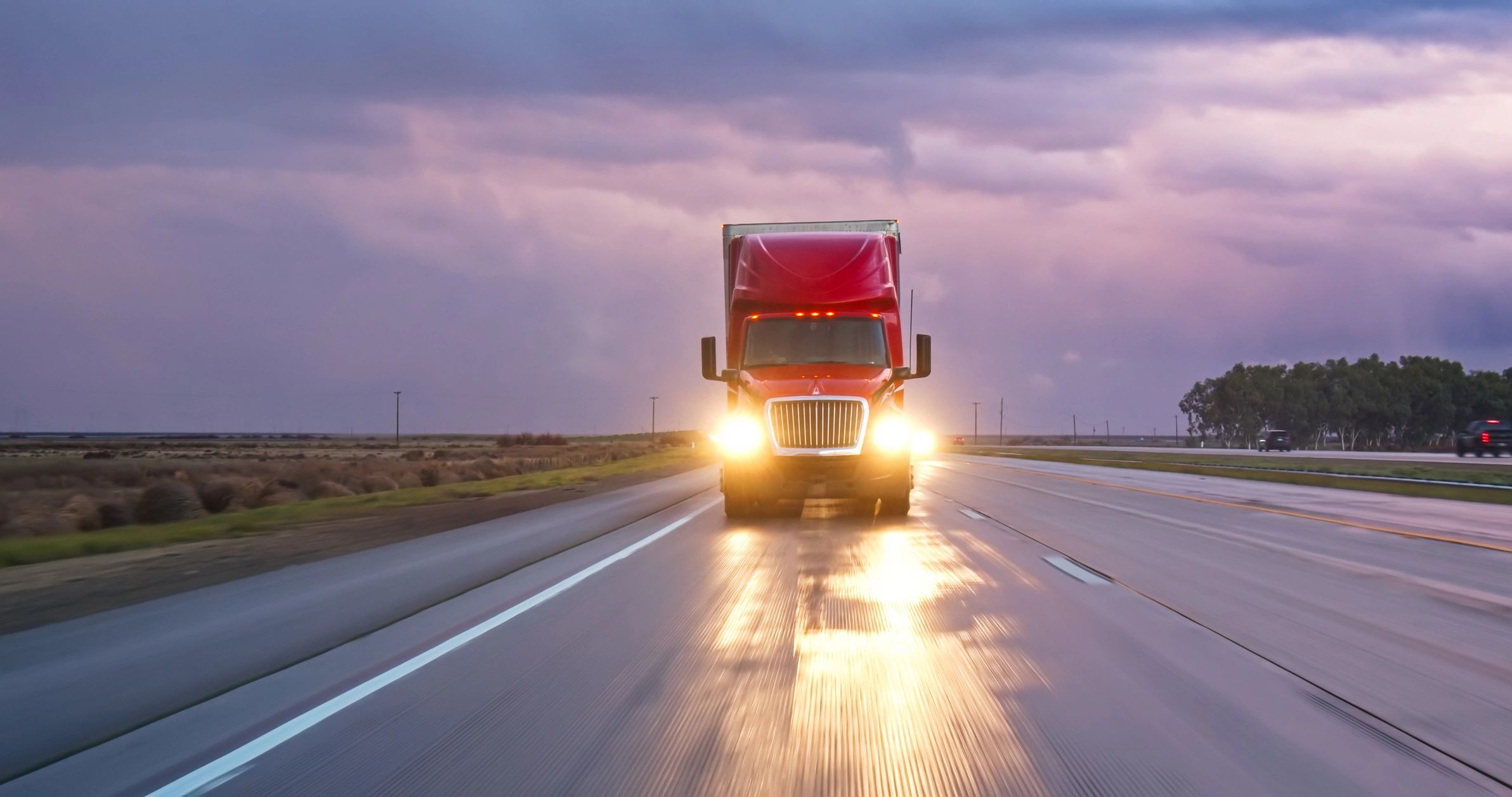 Cargo truck on highway at sunset representing road logistics
