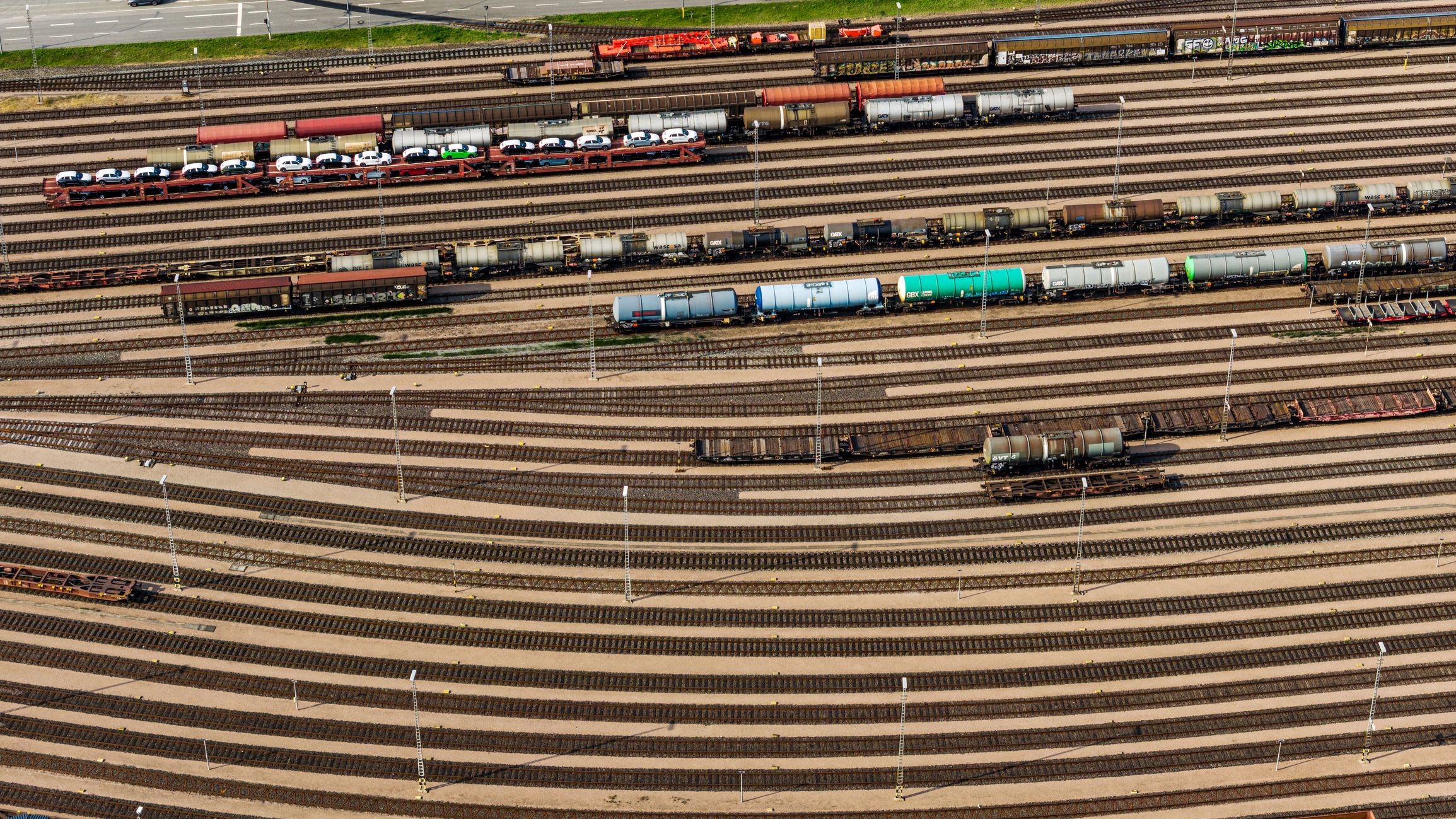 Aerial view of a freight rail yard with cargo trains